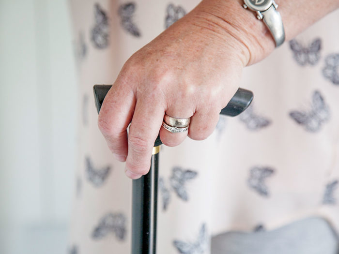 Woman's hand on a walking stick