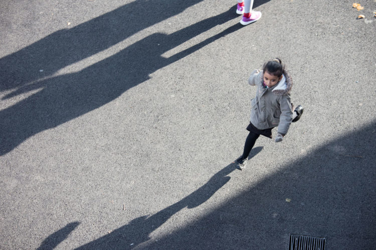 Child running in sunshine on playground