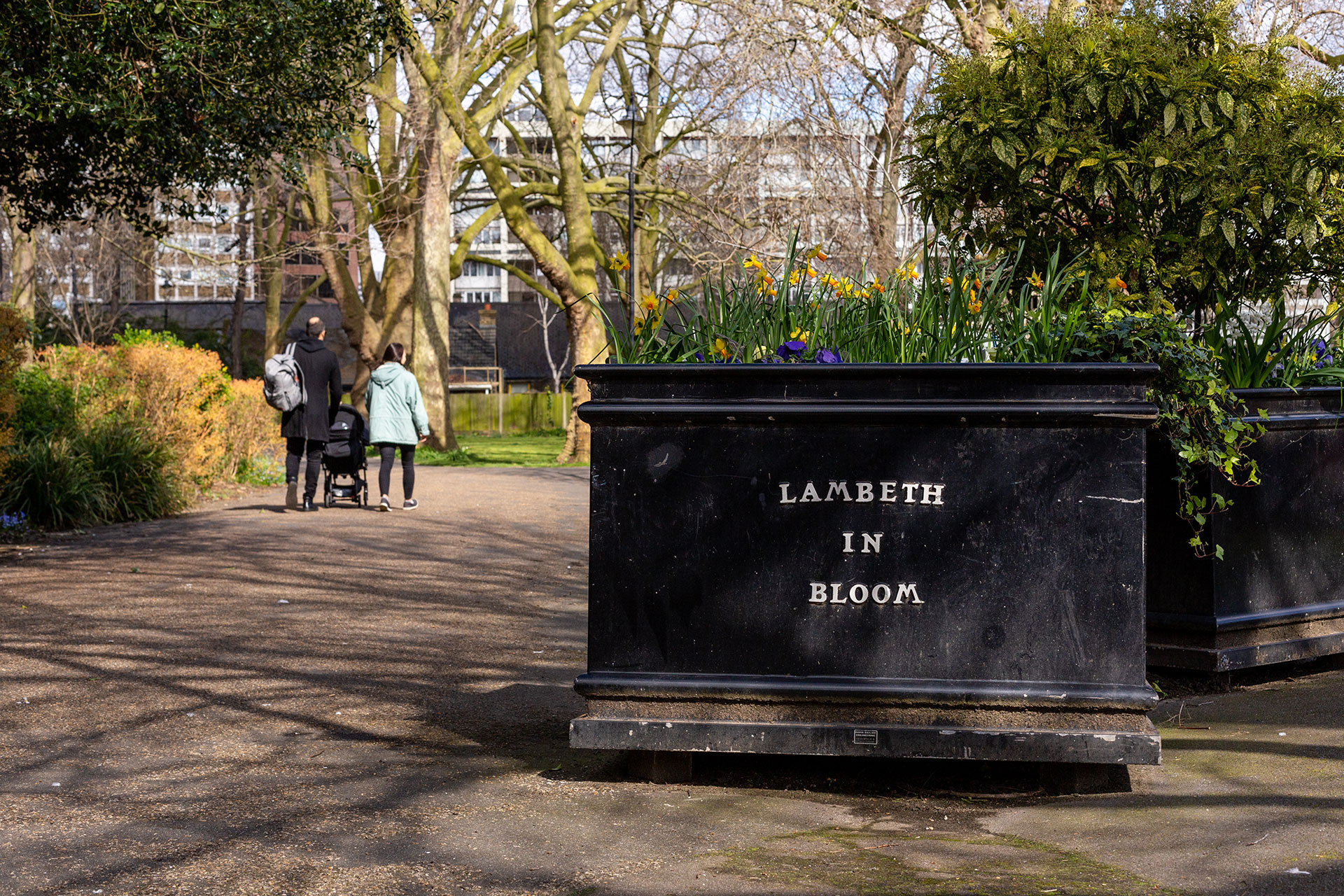 Park with a planter that has the label 'Lambeth in bloom'