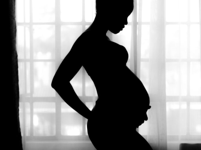 Pregnant woman in silhouette by Mustafa Omar