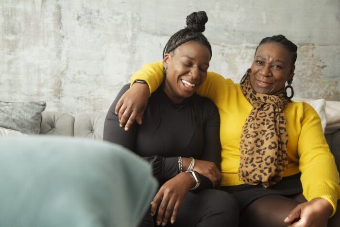 Two Black women laughing together