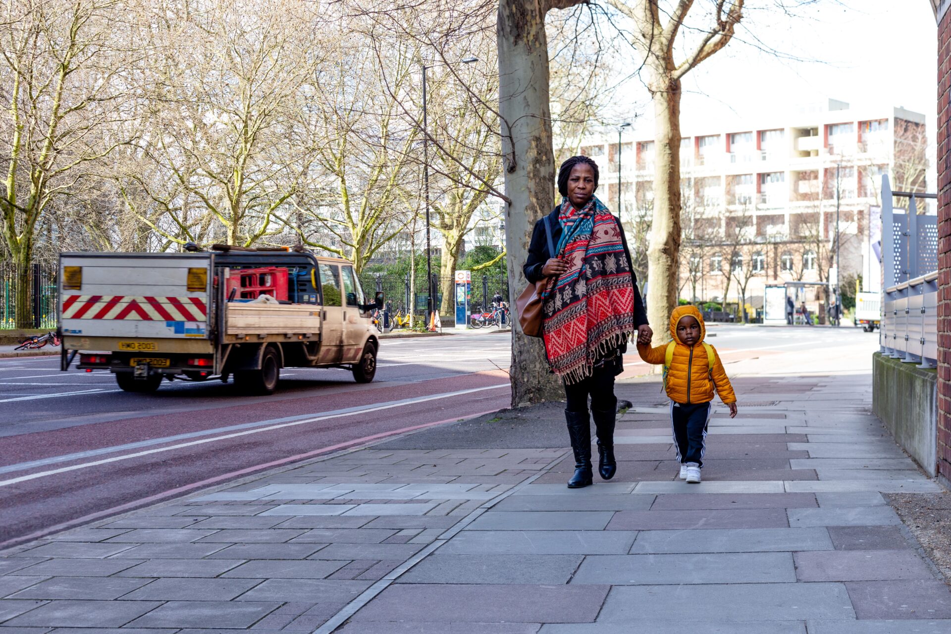 Mum and child walking along the pavement in a London street