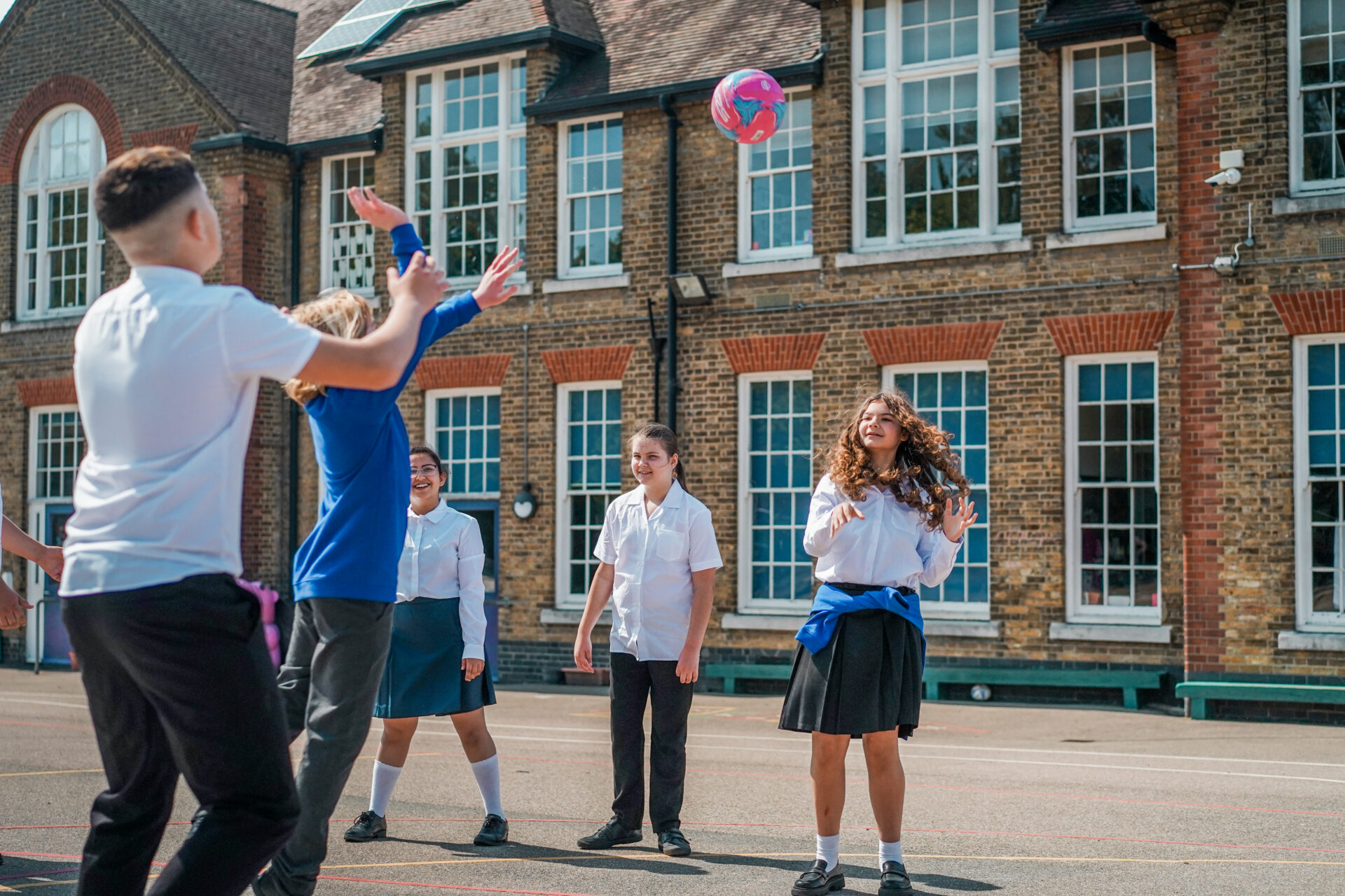 Children playing ball in school playground