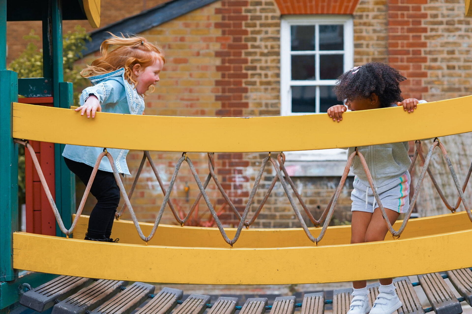 Children play on a bridge in a kids play area