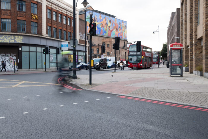 A street in London with shops, and a road.
