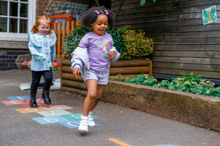 Two children playing hopscotch