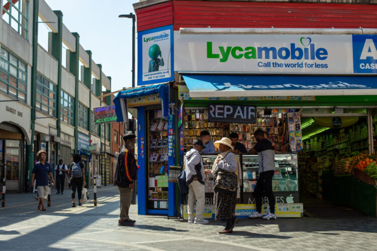 People standing outside a shop.