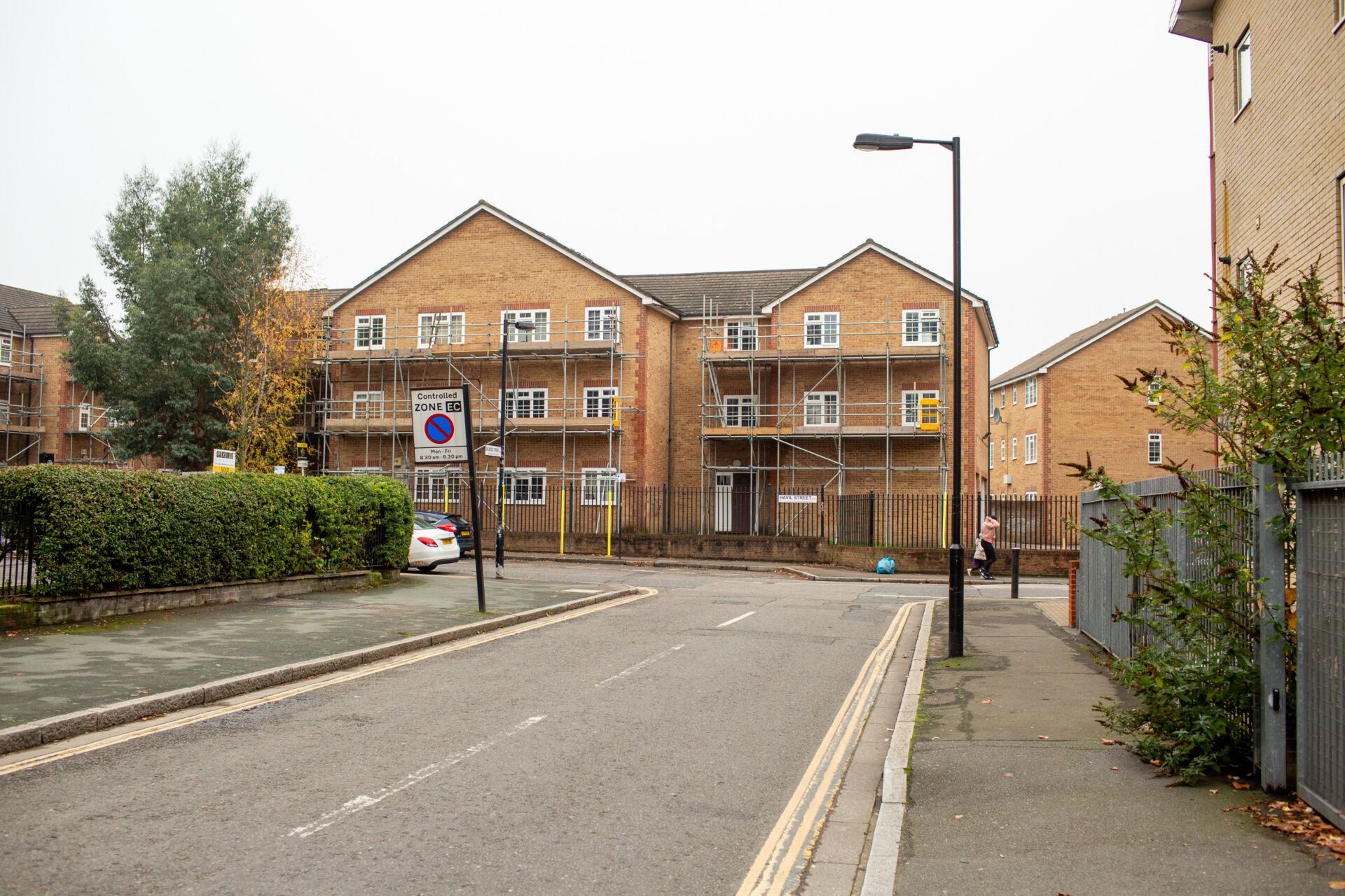 A road with a building of flats at the end.