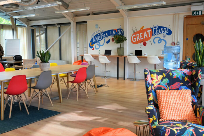 The%20Enterprise%20Hub.%20Chairs%20around%20a%20table.%20Computers%20on%20a%20desk.