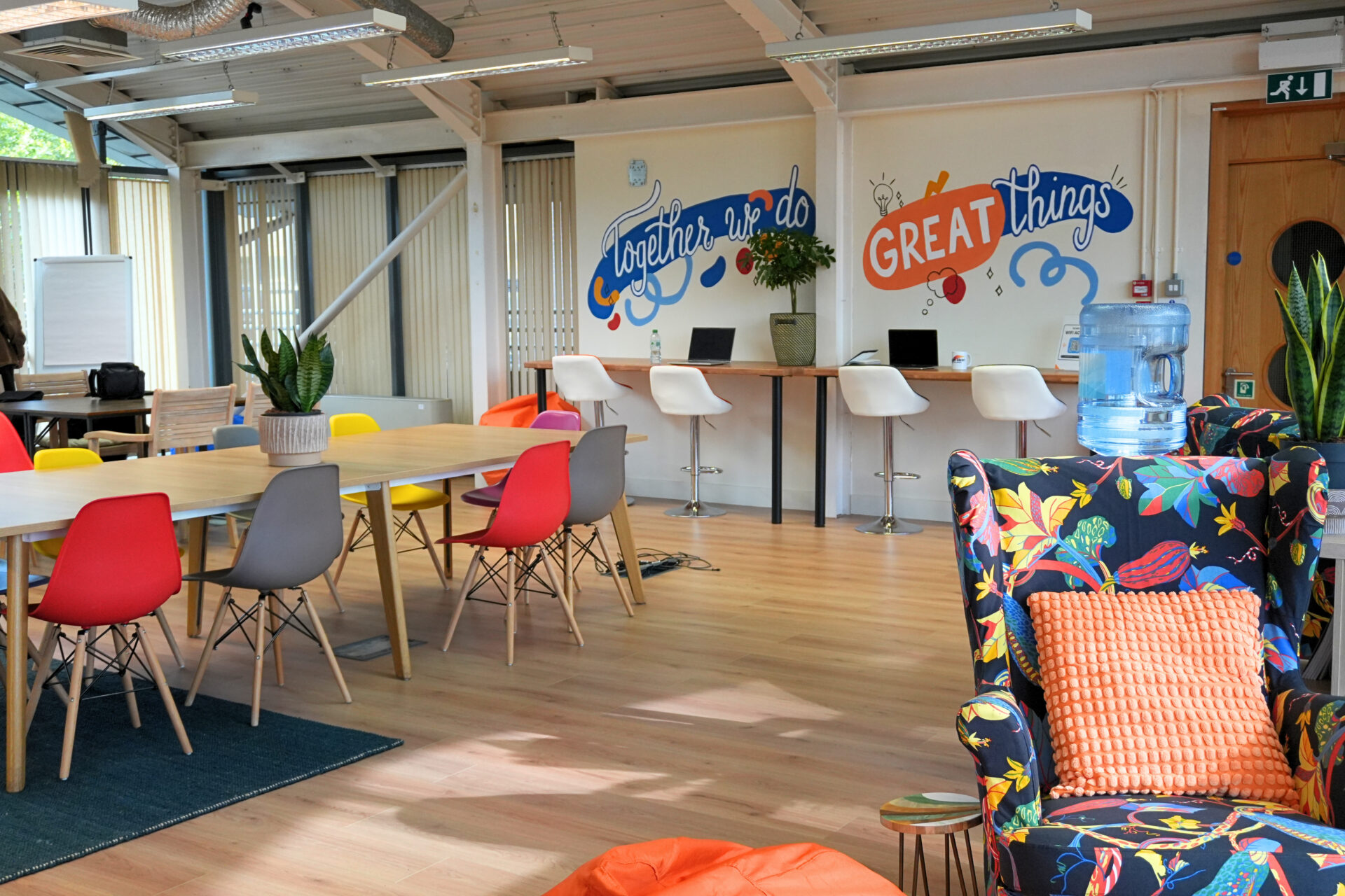 The Enterprise Hub. Chairs around a table. Computers on a desk.