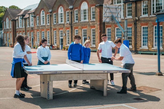 Children%20are%20playing%20table%20tennis%20in%20a%20school%20playground.