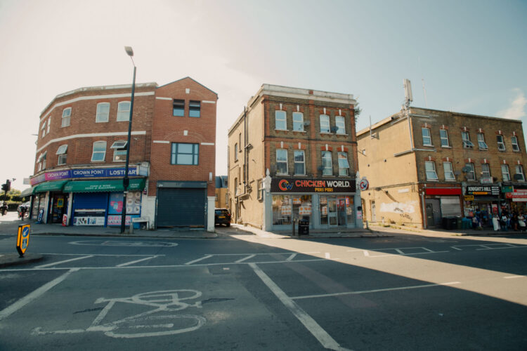 A high street in Norwood, south London with various convenience stores and fast food outlets.