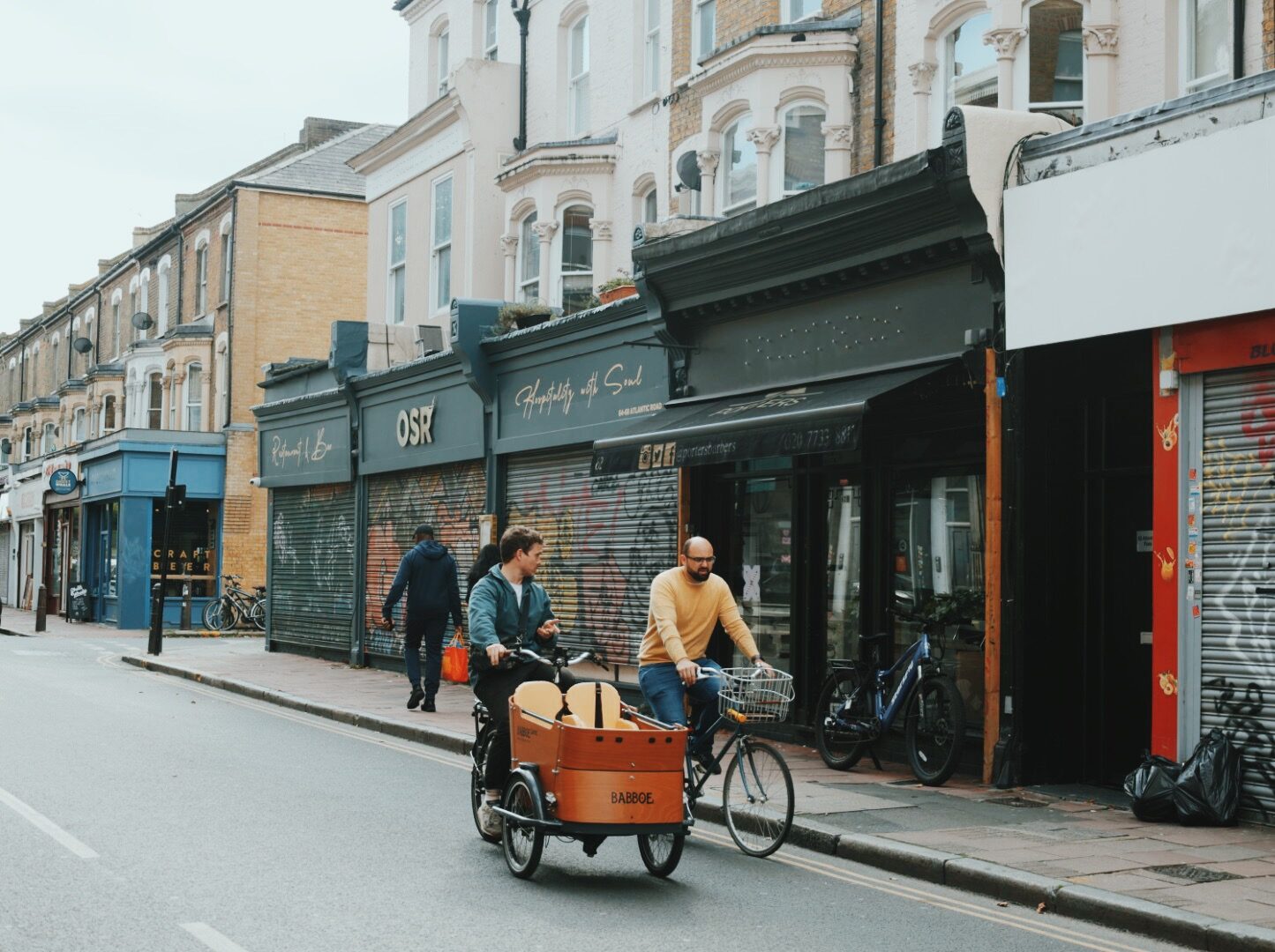 Two people cycling down Atlantic Road in Brixton.
